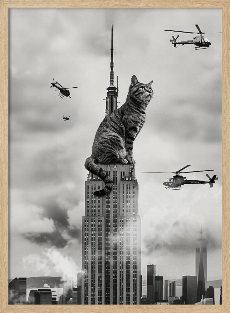 A surreal black and white image depicting a giant tabby cat sitting on top of the Empire State Building, similar to King Kong. Helicopters fly around the colossal cat against a cloudy New York City skyline. Decor