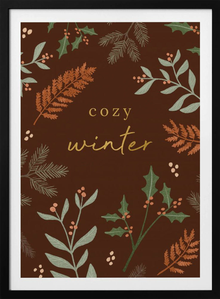 A warm, illustrative poster with a dark brown background featuring the words 'cozy winter' in gold script at the center. The text is framed by a wreath of winter botanicals, including holly, pine needles, and ferns in shades of green and burnt orange. Print