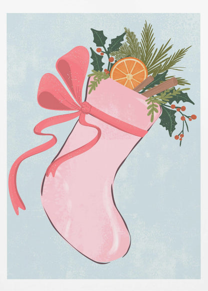 A festive illustration of a pink Christmas stocking against a light blue textured background. The stocking is tied with a large pink ribbon and is filled with holiday greenery, including holly with red berries, pine needles, a slice of dried orange, and cinnamon sticks. Decor