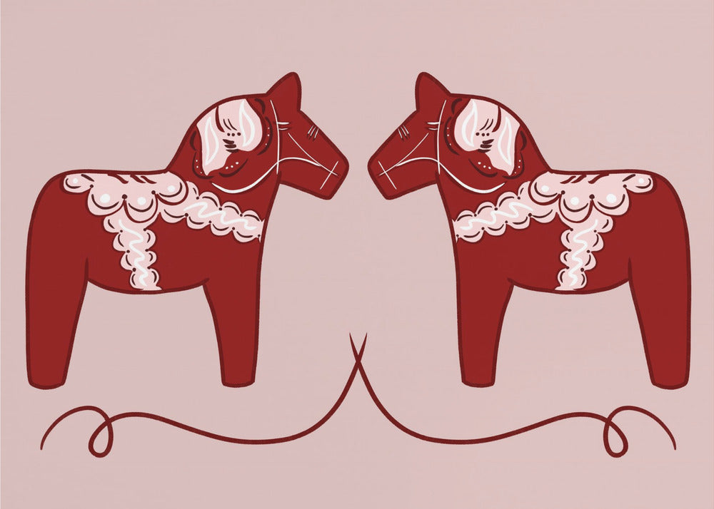 A symmetrical illustration of two red Swedish Dala horses facing each other against a light pink background. The horses are decorated with intricate white and pink folk art patterns. The artwork is presented within a silver frame. Artwork