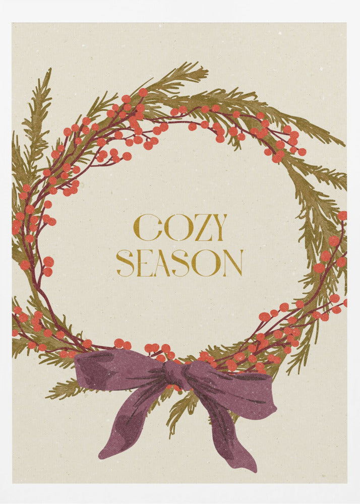A vintage-style illustration of a festive wreath made of green boughs and red berries, tied with a large purple bow at the bottom. The text 'COZY SEASON' is written in gold inside the wreath on a cream-colored background, all enclosed in a thin black frame. Wall Art