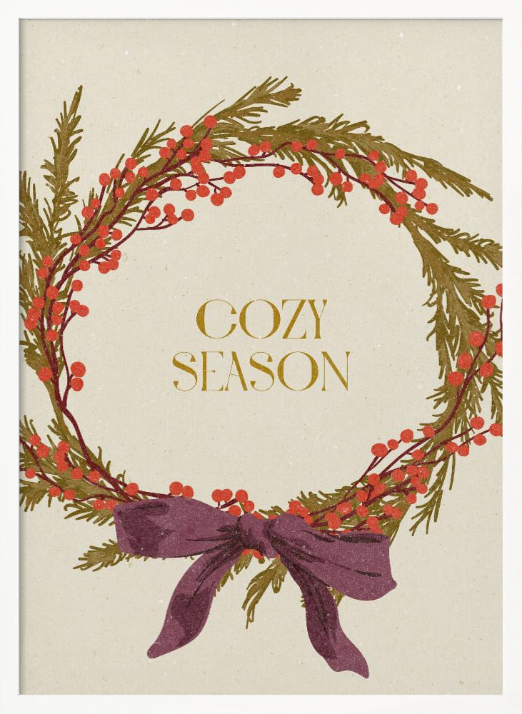 A vintage-style illustration of a festive wreath made of green boughs and red berries, tied with a large purple bow at the bottom. The text 'COZY SEASON' is written in gold inside the wreath on a cream-colored background, all enclosed in a thin black frame. Wall Art