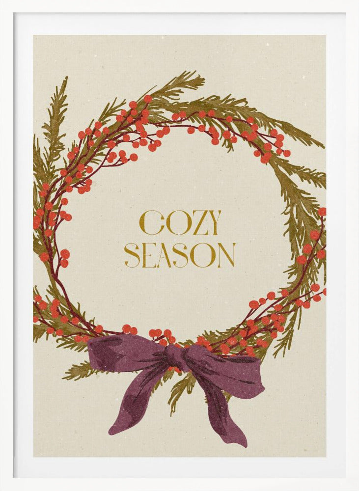 A vintage-style illustration of a festive wreath made of green boughs and red berries, tied with a large purple bow at the bottom. The text 'COZY SEASON' is written in gold inside the wreath on a cream-colored background, all enclosed in a thin black frame. Wall Art