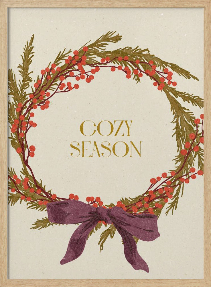 A vintage-style illustration of a festive wreath made of green boughs and red berries, tied with a large purple bow at the bottom. The text 'COZY SEASON' is written in gold inside the wreath on a cream-colored background, all enclosed in a thin black frame. Wall Art