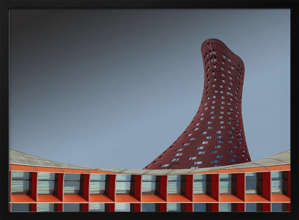 A modern architectural photograph showing a curved, maroon skyscraper twisting towards the sky against a gradient grey background. A lower, orange, grid-like building curves along the bottom of the frame. The entire scene is enclosed in a silver frame. Poster