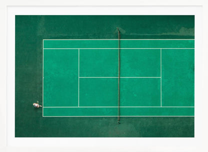 An aerial top-down photograph of a vibrant green tennis court with two players in the middle of a game, one on the far left and the other on the far right, all enclosed within a brushed silver frame. Print