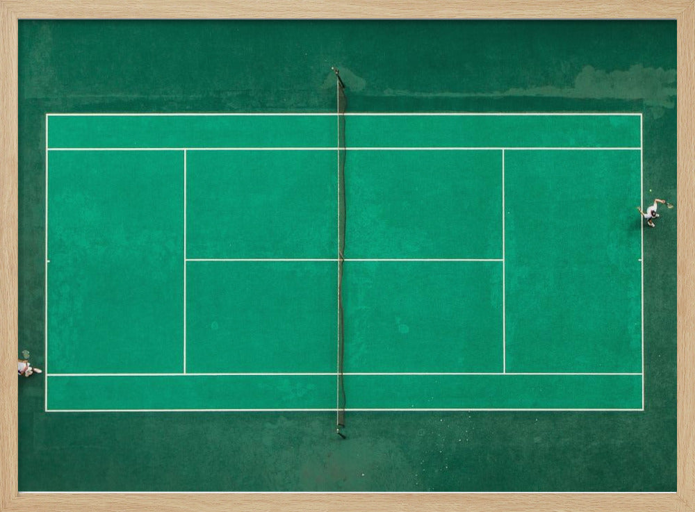 An aerial top-down photograph of a vibrant green tennis court with two players in the middle of a game, one on the far left and the other on the far right, all enclosed within a brushed silver frame. Print