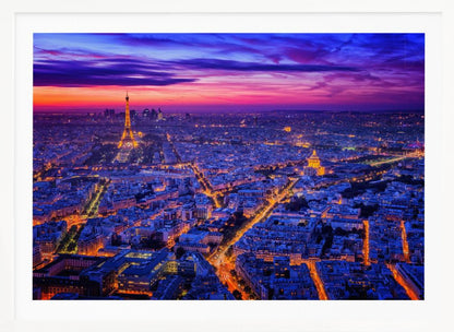 An aerial panoramic view of Paris at dusk, with the cityscape illuminated in cool blue and warm yellow lights. The Eiffel Tower is prominently lit on the left under a dramatic sunset sky transitioning from orange and pink to deep purple. Poster