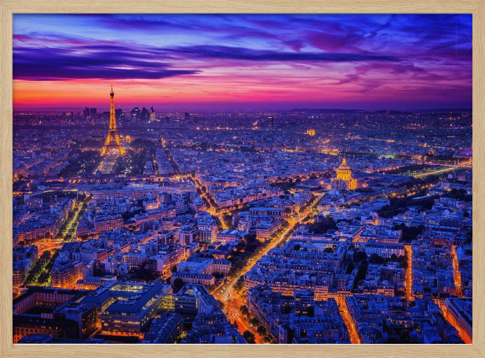 An aerial panoramic view of Paris at dusk, with the cityscape illuminated in cool blue and warm yellow lights. The Eiffel Tower is prominently lit on the left under a dramatic sunset sky transitioning from orange and pink to deep purple. Poster
