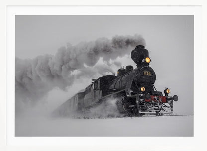 A dramatic black and white photograph of a classic steam train, number 1136, plowing through a heavy snowstorm, with its headlights glowing and a large plume of smoke trailing behind it. The image is presented within a silver frame. Print