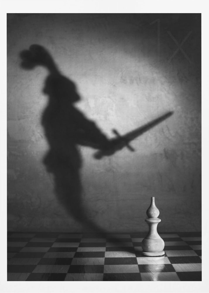 A black and white conceptual photograph of a single white chess piece on a checkerboard, casting a large, ominous shadow of a medieval knight holding a sword against a textured wall. Print
