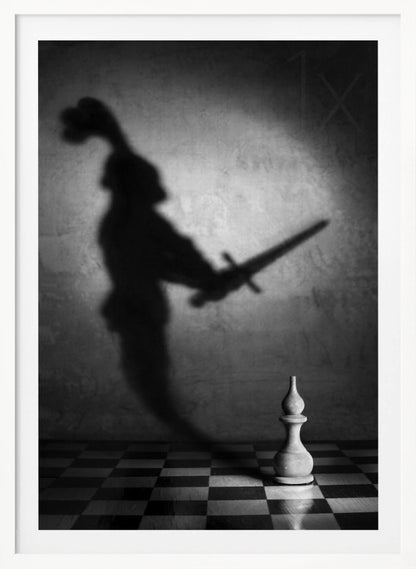 A black and white conceptual photograph of a single white chess piece on a checkerboard, casting a large, ominous shadow of a medieval knight holding a sword against a textured wall. Print