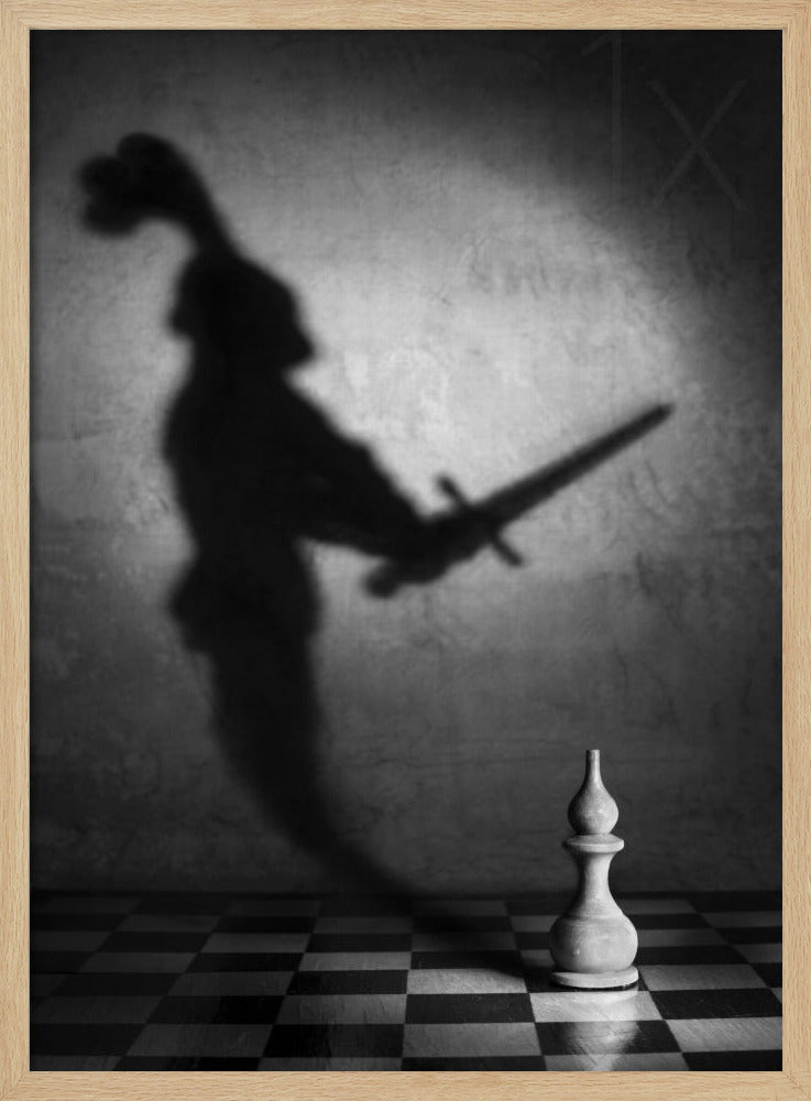 A black and white conceptual photograph of a single white chess piece on a checkerboard, casting a large, ominous shadow of a medieval knight holding a sword against a textured wall. Print