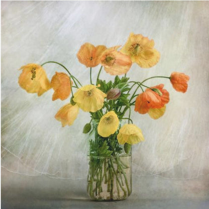 A soft-focus still life photograph of a bouquet of yellow and orange poppies in a clear glass jar, set against a delicate, light green textured background, all enclosed in a light wood frame. Print