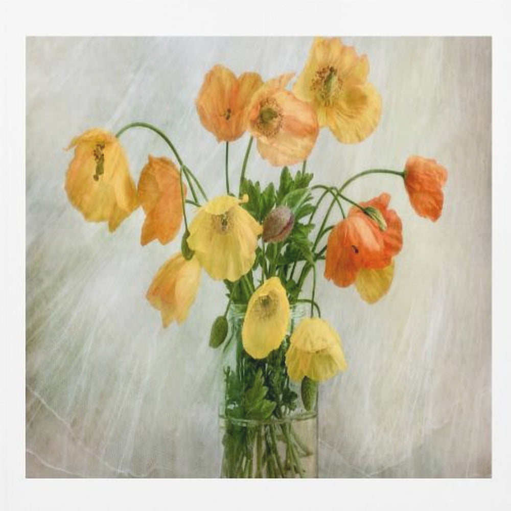 A soft-focus still life photograph of a bouquet of yellow and orange poppies in a clear glass jar, set against a delicate, light green textured background, all enclosed in a light wood frame. Print