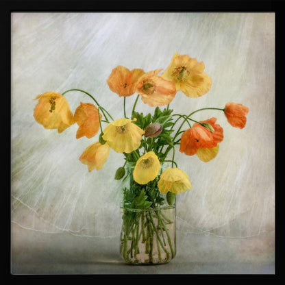 A soft-focus still life photograph of a bouquet of yellow and orange poppies in a clear glass jar, set against a delicate, light green textured background, all enclosed in a light wood frame. Print