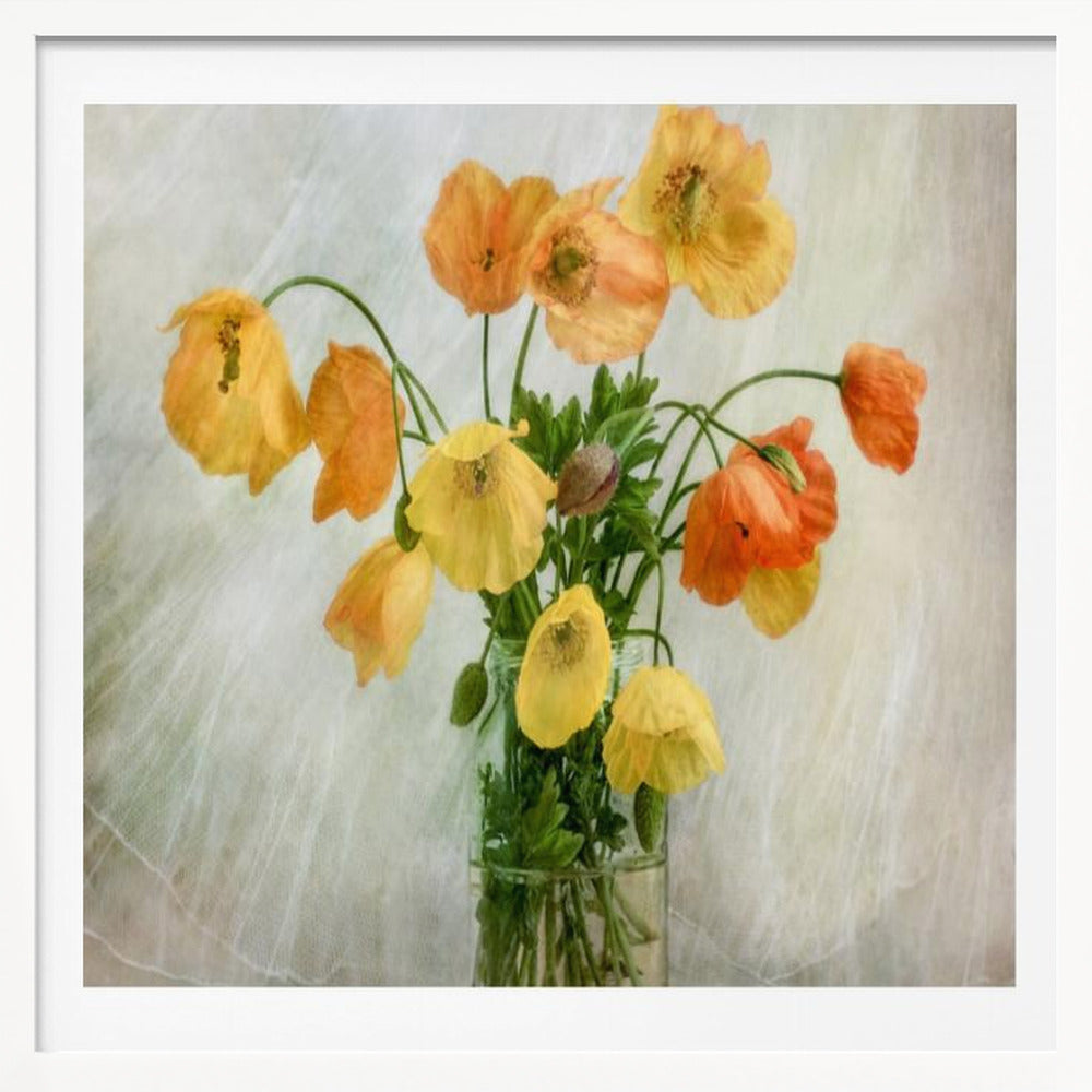 A soft-focus still life photograph of a bouquet of yellow and orange poppies in a clear glass jar, set against a delicate, light green textured background, all enclosed in a light wood frame. Print