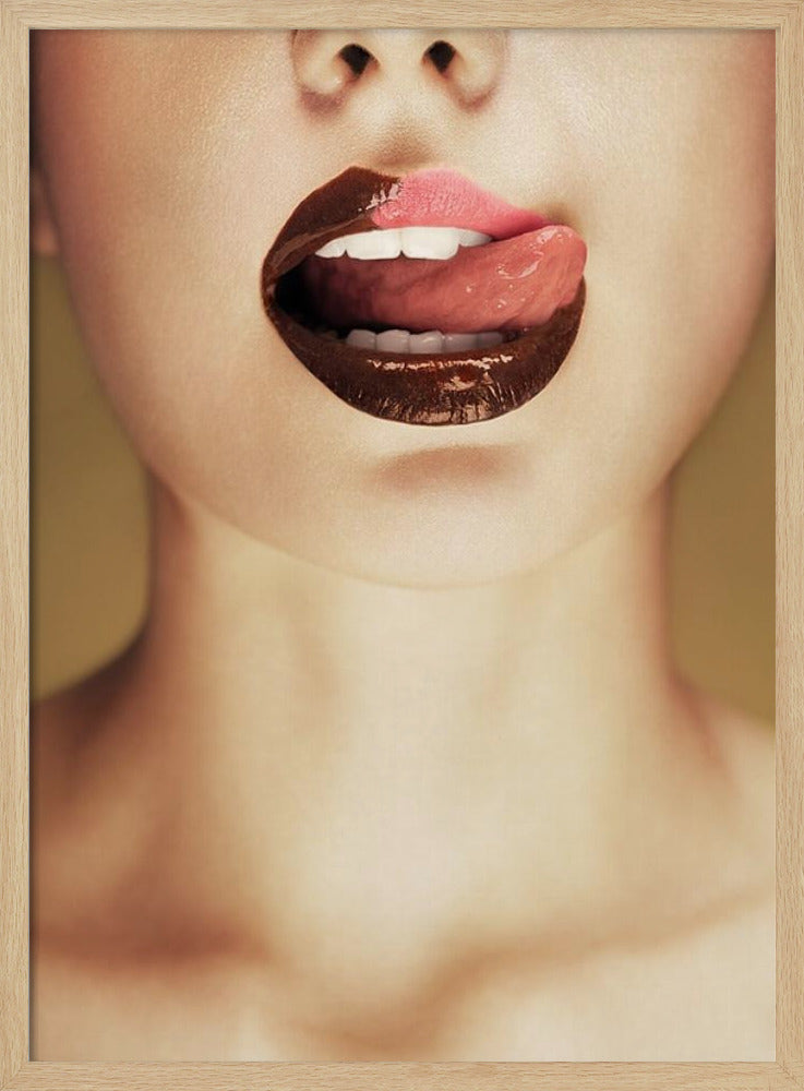 A close-up photograph of a woman's mouth with two-toned lipstick. The lips are mostly covered in glossy dark brown, with the upper right section in light pink. Her tongue is out, licking the pink part of her lip, revealing her white teeth. Print