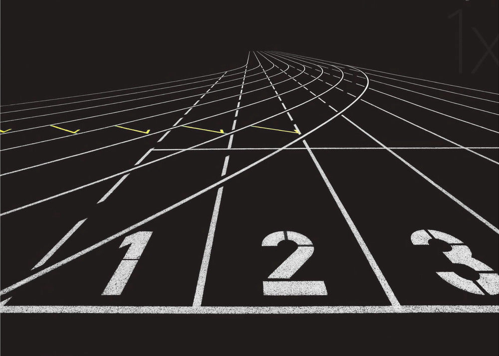 A framed, high-contrast graphic of a black running track from a low-angle perspective at the starting line. White lines delineate the lanes, with the numbers 1, 2, and 3 stenciled in the foreground. The track curves and recedes into the distance, creating a strong sense of perspective. Decor