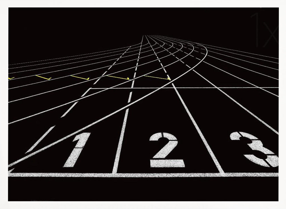 A framed, high-contrast graphic of a black running track from a low-angle perspective at the starting line. White lines delineate the lanes, with the numbers 1, 2, and 3 stenciled in the foreground. The track curves and recedes into the distance, creating a strong sense of perspective. Decor