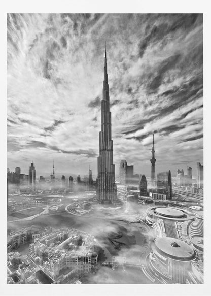 A dramatic black and white high-angle photograph of the Burj Khalifa dominating the Dubai cityscape, with swirling clouds above and a light mist surrounding the buildings below, all enclosed in a black frame. Poster