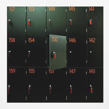 A head-on shot of a grid of black lockers inside a light wood frame. Each locker has a bright orange number and a key with a red tag. Locker number 150 is open, creating a focal point in the otherwise uniform pattern. Wall Art