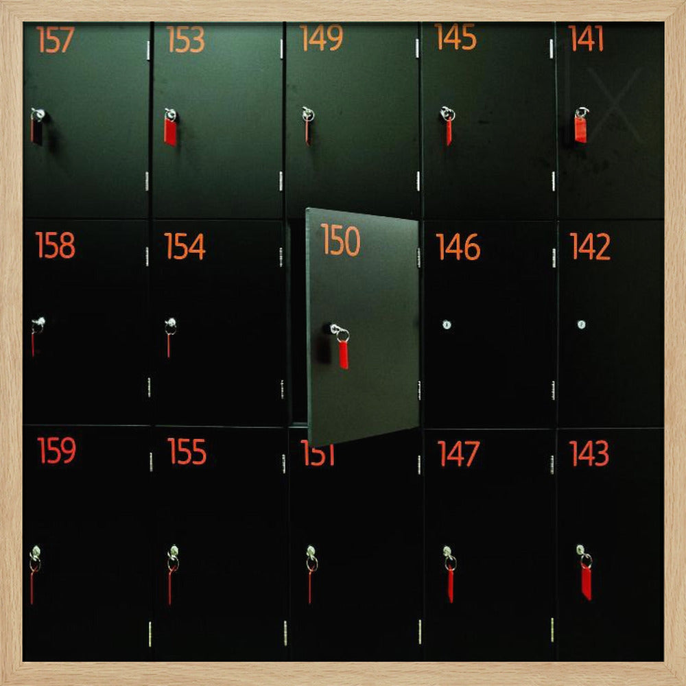 A head-on shot of a grid of black lockers inside a light wood frame. Each locker has a bright orange number and a key with a red tag. Locker number 150 is open, creating a focal point in the otherwise uniform pattern. Wall Art