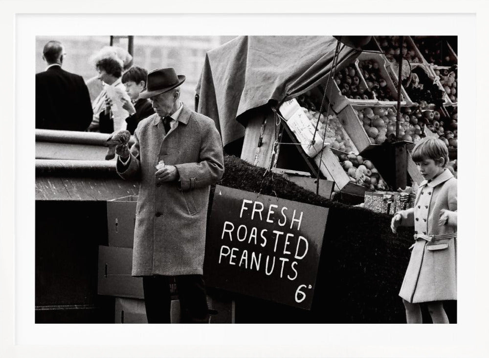 A vintage black and white photograph of an elderly man in a fedora and overcoat feeding a pigeon from his hand at an outdoor market. A sign for 'FRESH ROASTED PEANUTS' is visible next to him, and a young boy in a coat watches nearby. Wall Art