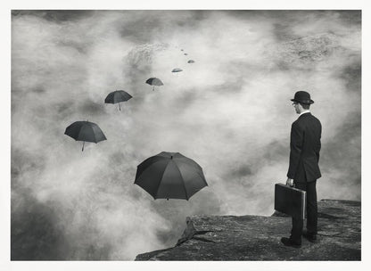 A surreal black and white photograph of a man in a suit and bowler hat holding a briefcase, standing on a cliff edge. He gazes into a foggy expanse where a path of floating black umbrellas leads into the misty distance. Decor