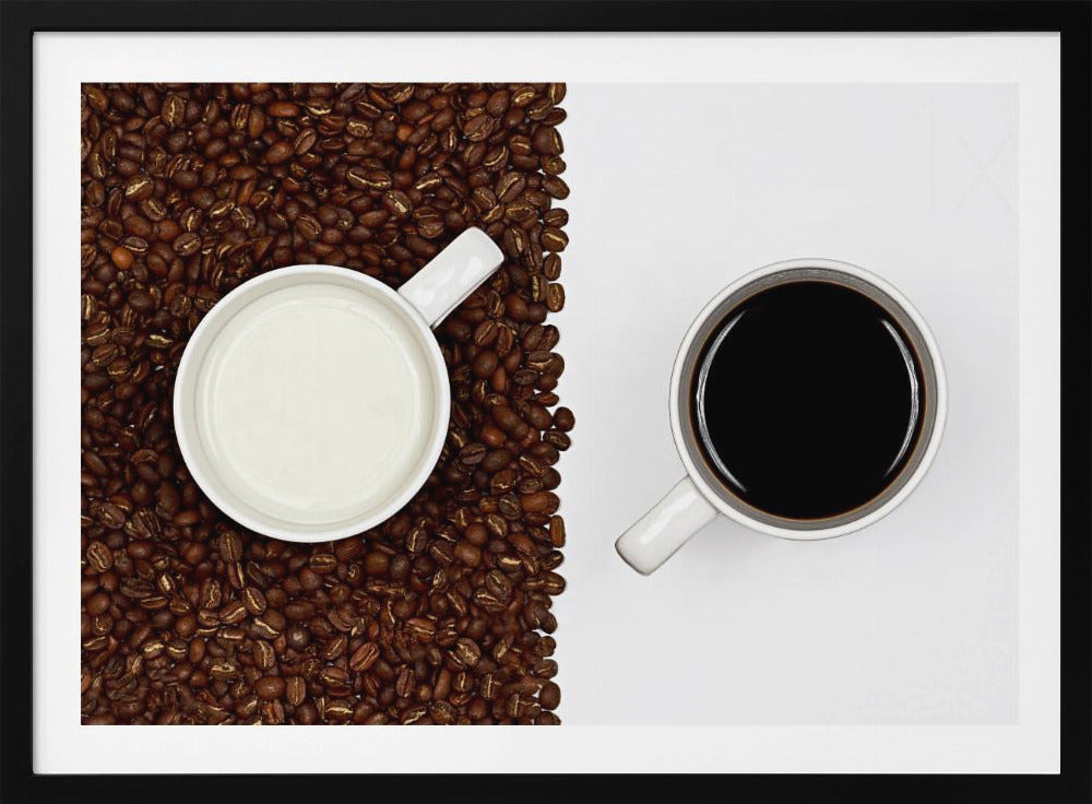 A top-down, split-screen photograph showing a contrast between coffee and milk. On the left, a white mug of milk sits on a bed of roasted coffee beans. On the right, a white mug of black coffee rests on a clean white background, creating a stark visual divide. Artwork