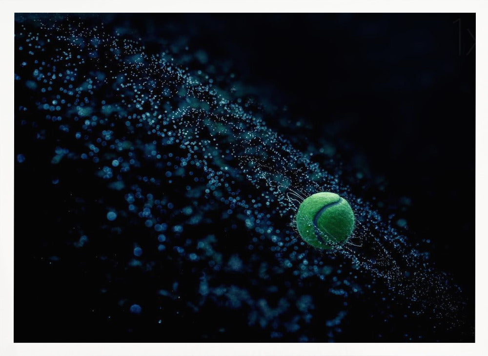 A high-speed photograph captures a spinning green tennis ball against a black background, with a dramatic spray of blue-lit water droplets flying off it in a cosmic-like spiral. Artwork