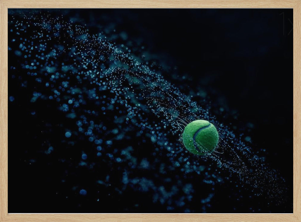 A high-speed photograph captures a spinning green tennis ball against a black background, with a dramatic spray of blue-lit water droplets flying off it in a cosmic-like spiral. Artwork