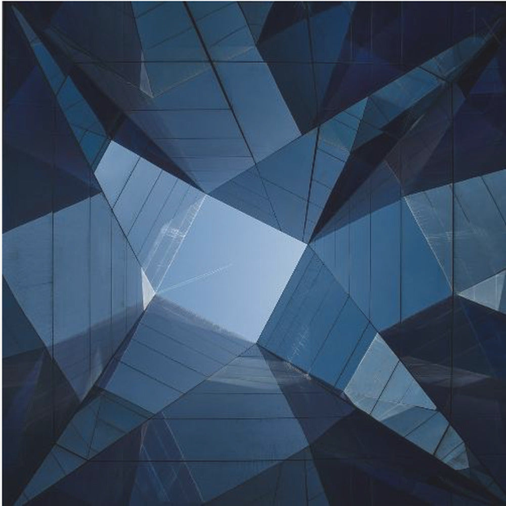 A framed, low-angle photograph looking up towards the sky, surrounded by the reflective blue glass facades of modern buildings which create a kaleidoscopic, geometric pattern. Print