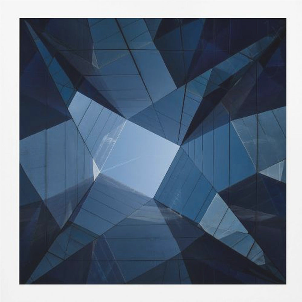 A framed, low-angle photograph looking up towards the sky, surrounded by the reflective blue glass facades of modern buildings which create a kaleidoscopic, geometric pattern. Print