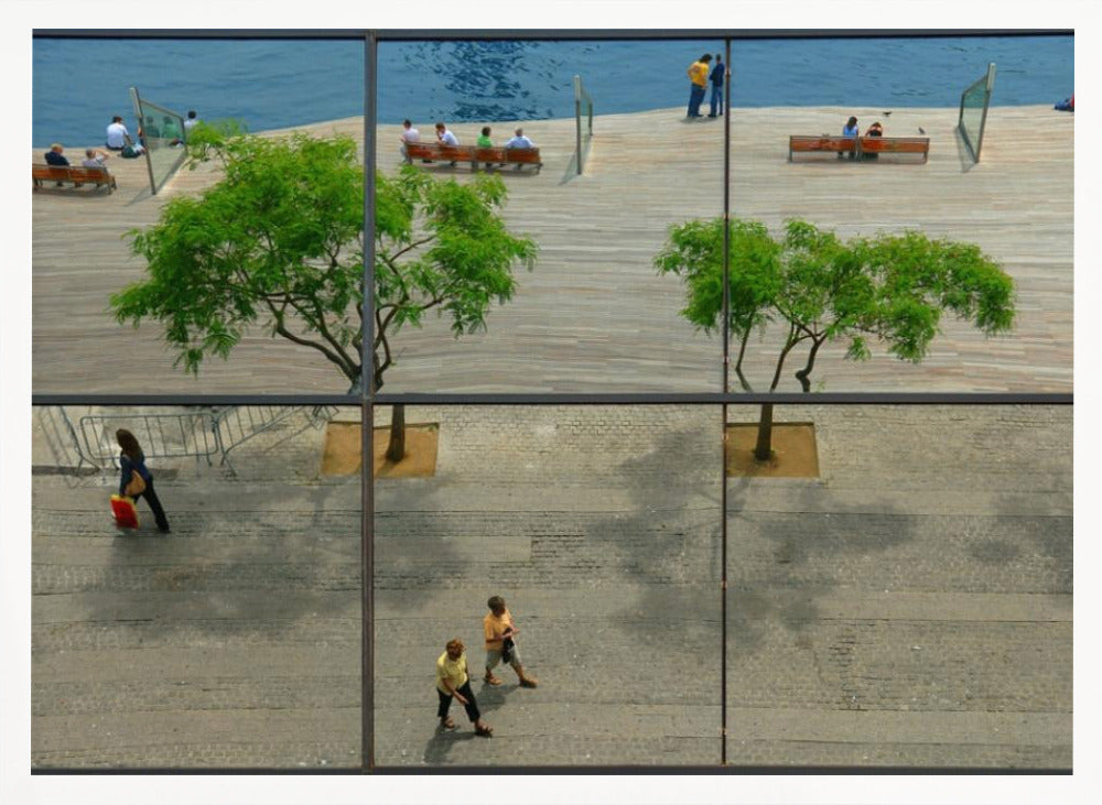 A framed, multi-pane window view showing a composite urban scene. The top panes reflect a sunny day on a wooden boardwalk by blue water, with people relaxing and green trees. The bottom panes show a direct view of a paved street below, with a few pedestrians walking. The window mullions create a grid that divides the distinct scenes. Wall Art