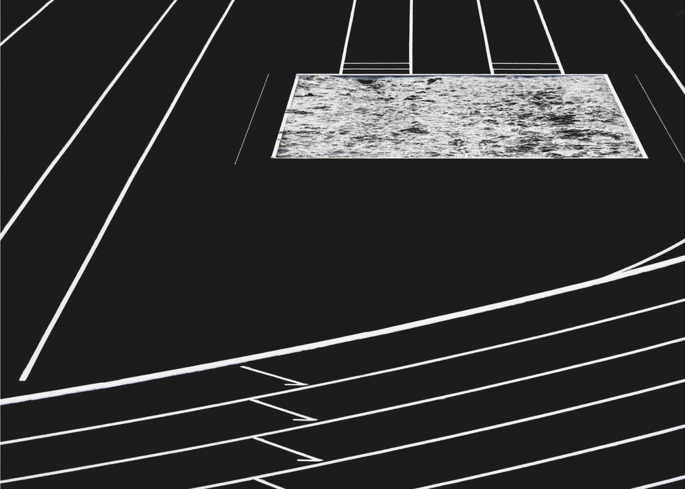 A high-contrast, black and white abstract artwork depicting a running track from an elevated perspective. Stark white lines representing lanes curve across a solid black background. In the upper portion, a rectangular shape filled with a textured, water-like pattern replaces a typical sand pit. The entire piece is presented within a silver frame. Print