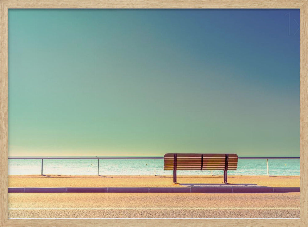 A minimalist, retro-toned photograph of a solitary wooden bench on a sunlit seaside promenade, overlooking a calm turquoise ocean under a vast, clear blue-green sky. Poster