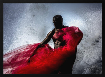 A dramatic photograph of a muscular Black man, mostly in shadow, holding a voluminous, sheer red fabric against a backdrop of splashing white water. The image is encased in a silver frame. Poster