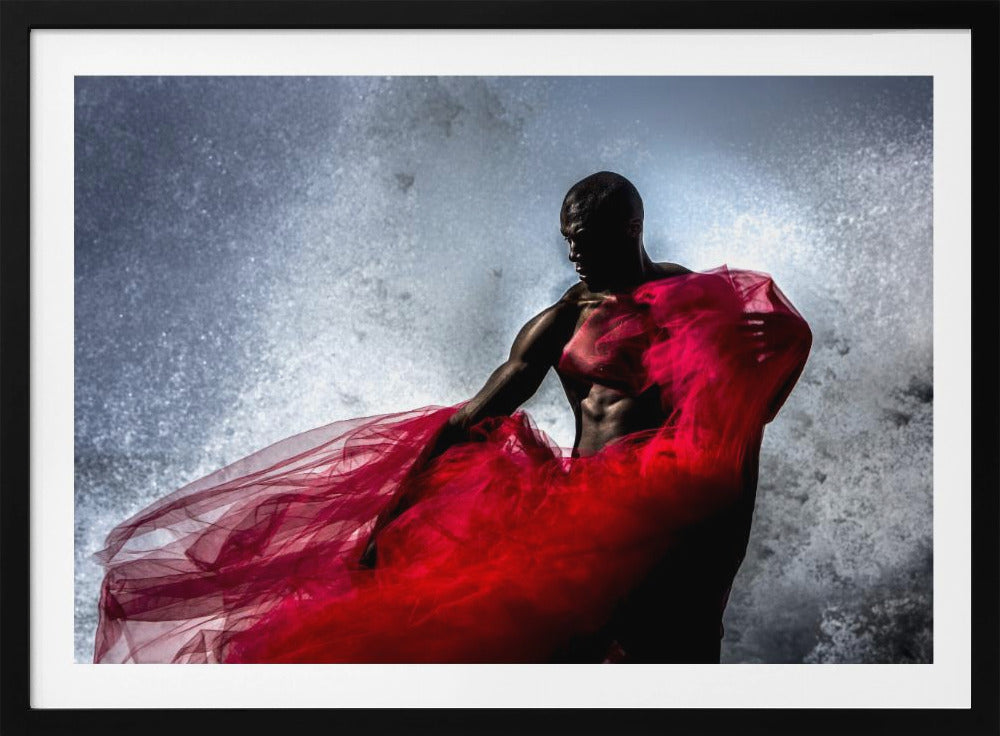 A dramatic photograph of a muscular Black man, mostly in shadow, holding a voluminous, sheer red fabric against a backdrop of splashing white water. The image is encased in a silver frame. Poster
