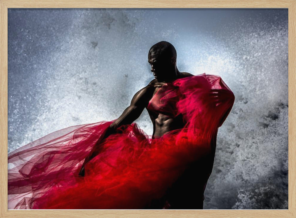 A dramatic photograph of a muscular Black man, mostly in shadow, holding a voluminous, sheer red fabric against a backdrop of splashing white water. The image is encased in a silver frame. Poster
