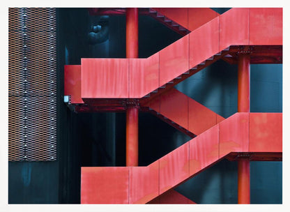 A framed abstract architectural photograph of a bright red industrial staircase zig-zagging against a dark teal wall. The composition highlights the geometric shapes and bold color contrast between the red stairs and the cool-toned background, with a silver mesh panel visible on the left side. Print