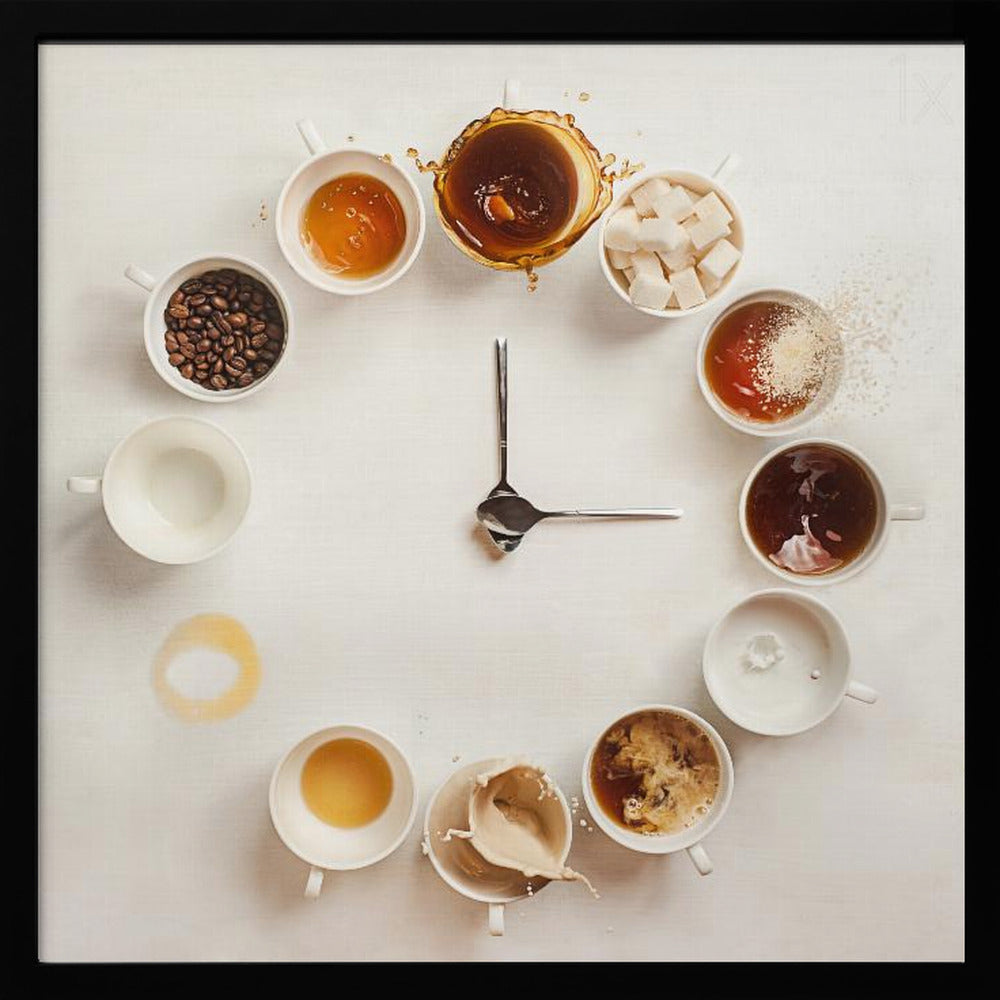A creative flat lay photograph of a clock made from coffee cups and ingredients. Twelve white cups are arranged in a circle on a white background, each representing an hour and filled with different coffee-related items like beans, honey, sugar cubes, and various stages of coffee with milk splashing. In the center, two silver spoons form the hands of the clock. The entire image is presented within a light wood frame. Decor