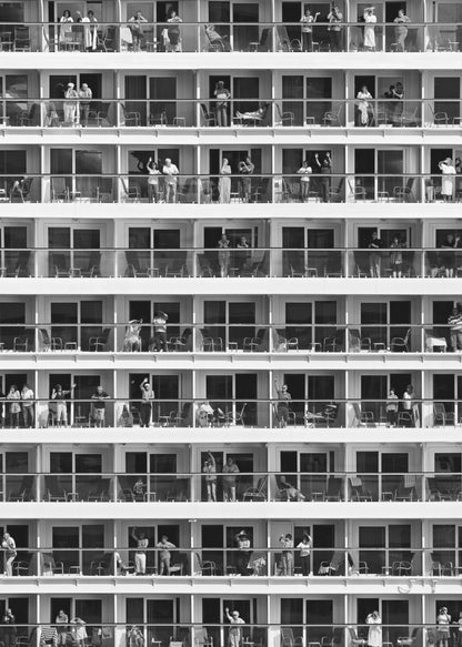 A black and white, high-contrast photograph of the side of a cruise ship, showing a grid of balconies across multiple decks. Various passengers are visible on their balconies, some waving, some relaxing, and some observing, creating a pattern of individual human stories within the repetitive architectural structure. Poster