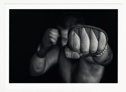 A dramatic black and white close-up photograph of a boxer's wrapped fist punching towards the camera. The fighter's body and other fist are blurred in the background, creating a powerful and intense mood. Print