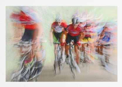 An abstract photograph of a group of cyclists in a race, captured with motion blur to create a dynamic sense of speed. The riders' red jerseys and the green background are streaked together, with a silver frame surrounding the image. Artwork