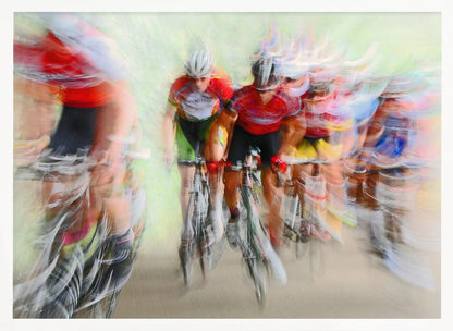 An abstract photograph of a group of cyclists in a race, captured with motion blur to create a dynamic sense of speed. The riders' red jerseys and the green background are streaked together, with a silver frame surrounding the image. Artwork