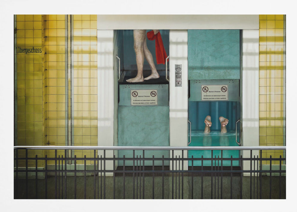 A surreal, framed artwork depicting two teal-colored vertical cabins against a yellow tiled wall. In the left cabin, a person's bare legs are visible as they hold a red towel. In the right cabin, which is filled with water, only a pair of feet can be seen submerged. A black railing is in the foreground, adding to the strange, layered composition. Artwork