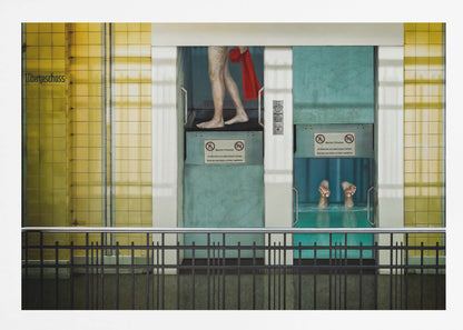 A surreal, framed artwork depicting two teal-colored vertical cabins against a yellow tiled wall. In the left cabin, a person's bare legs are visible as they hold a red towel. In the right cabin, which is filled with water, only a pair of feet can be seen submerged. A black railing is in the foreground, adding to the strange, layered composition. Artwork