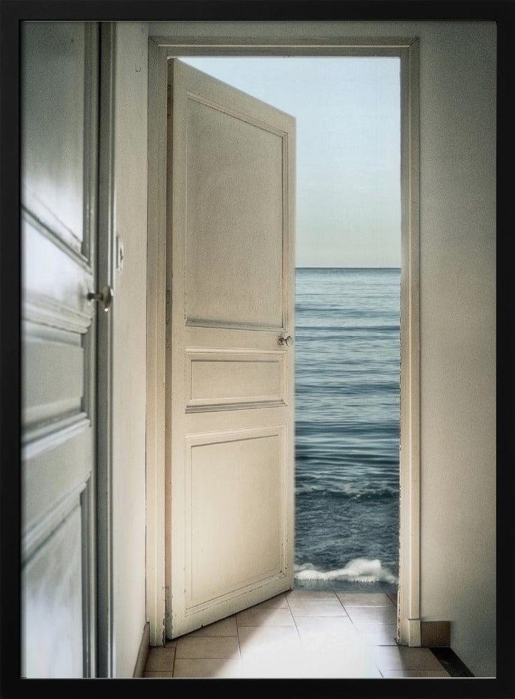 A surreal photograph showing a white interior door swung open, revealing not a landscape but the vast blue ocean, with waves gently washing over the tiled floor of the room. Decor