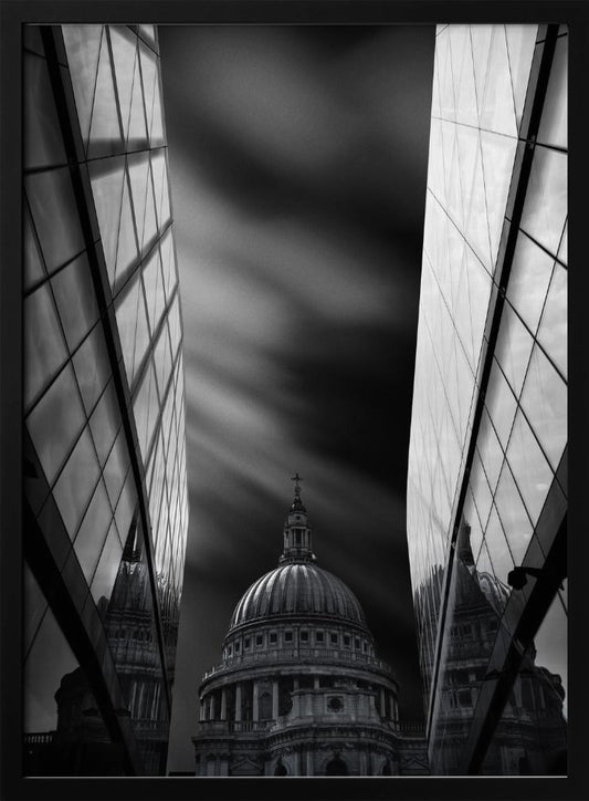 A dramatic black and white, low-angle photograph of St. Paul's Cathedral in London, framed between two modern, reflective glass skyscrapers. A long exposure effect blurs the clouds in the sky, creating streaks of light and shadow behind the cathedral's dome. Poster